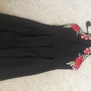 Black halterneck dress with rose detail